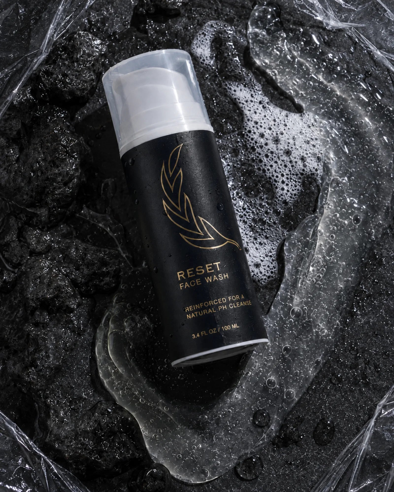 Reset face wash surrounded by cleansing texture and water
